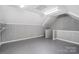 A bonus room space with neutral gray paneling and flooring, great for storage or home office use at 17315 Langston Dr, Charlotte, NC 28278