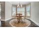 Cozy breakfast nook with a round table, four chairs, and large windows for ample natural light at 17315 Langston Dr, Charlotte, NC 28278