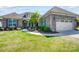 Charming brick home featuring a well-manicured lawn and two-car garage at 17315 Langston Dr, Charlotte, NC 28278
