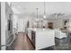 A spacious kitchen featuring stainless steel appliances, a wine cooler, and pendant lighting at 17315 Langston Dr, Charlotte, NC 28278