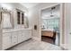 Main bathroom leading to the main bedroom; double vanity with decorative mirrors at 17315 Langston Dr, Charlotte, NC 28278