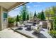 Outdoor living space with a built in brick oven, chairs surrounding an outdoor fireplace, perfect for entertaining at 17315 Langston Dr, Charlotte, NC 28278