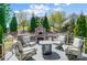 Outdoor living space with a built in brick oven, chairs surrounding an outdoor fireplace, perfect for entertaining at 17315 Langston Dr, Charlotte, NC 28278