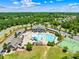 Aerial view of community amenities, including a pool, playground, tennis courts, and surrounding greenery at 17413 Caddy Ct, Charlotte, NC 28278