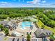 Aerial view of community amenities, including a pool, playground, tennis courts, and surrounding greenery at 17413 Caddy Ct, Charlotte, NC 28278