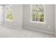 Sunlit bedroom offering plush carpets and a wall with two large windows, inviting natural light at 17413 Caddy Ct, Charlotte, NC 28278