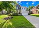 Charming two-story home with a well-manicured lawn, inviting front porch, and a two-car garage at 17413 Caddy Ct, Charlotte, NC 28278