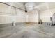 Unfinished garage with concrete floor, drywall, garage door opener, and utility connections at 17413 Caddy Ct, Charlotte, NC 28278