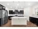 Modern kitchen featuring dark cabinetry, stainless steel appliances, and a central island at 17413 Caddy Ct, Charlotte, NC 28278