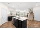 Modern kitchen featuring an island with a sink, stainless steel appliances, and light countertops at 17413 Caddy Ct, Charlotte, NC 28278
