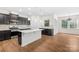 Open kitchen with wood floors, stylish island and stainless steel appliances at 17413 Caddy Ct, Charlotte, NC 28278