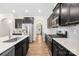 A modern kitchen with stainless steel appliances and spacious countertops with white backsplash at 17413 Caddy Ct, Charlotte, NC 28278