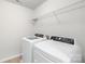 Functional laundry room with modern washer and dryer and wire rack shelving for organized storage at 17413 Caddy Ct, Charlotte, NC 28278