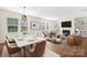 Stylishly furnished living room and dining area with a marble table and a cozy fireplace at 17413 Caddy Ct, Charlotte, NC 28278
