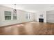 Spacious living room with hardwood floors, built-in bookshelves, and a cozy fireplace at 17413 Caddy Ct, Charlotte, NC 28278
