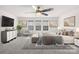 A bedroom with a ceiling fan, three windows and a sitting area at 17413 Caddy Ct, Charlotte, NC 28278