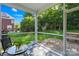 Cozy screened porch with a round table and a view of the backyard at 17413 Caddy Ct, Charlotte, NC 28278