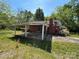 Charming exterior with a covered carport and lush yard, offering a canvas for updates and personalization at 191 S Main St, Richburg, SC 29729