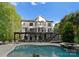 A backyard view showcases a beautiful pool, a covered patio and outdoor seating area, perfect for entertaining or relaxing at 200 Royalton Pl, Huntersville, NC 28078