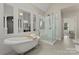 Serene primary bathroom featuring a clawfoot tub, glass shower, and elegant finishes at 200 Royalton Pl, Huntersville, NC 28078