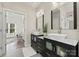 Modern bathroom boasts double vanities, marble countertops, and decorative mirrors creating spa-like space at 200 Royalton Pl, Huntersville, NC 28078