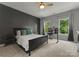 Well-lit bedroom features a ceiling fan, accent wall, and dual windows at 200 Royalton Pl, Huntersville, NC 28078