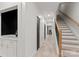 Bright hallway featuring staircase, tile flooring, and black paneled doors at 200 Royalton Pl, Huntersville, NC 28078