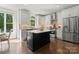 Modern kitchen features stainless steel appliances, island with marble countertop, and hardwood floors at 200 Royalton Pl, Huntersville, NC 28078