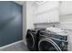 Modern laundry room with front-load washer/dryer, subway tile backsplash and white cabinets at 200 Royalton Pl, Huntersville, NC 28078