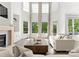 Bright and airy living room boasts vaulted ceilings, fireplace, and scenic views at 200 Royalton Pl, Huntersville, NC 28078