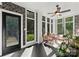 Bright sunroom with many windows, ceiling fan, and outdoor view creating tranquil space at 200 Royalton Pl, Huntersville, NC 28078