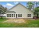 Back exterior of home featuring a concrete patio and a well manicured lawn at 212 Kilborne Rd, Mooresville, NC 28117