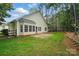 Back exterior of home featuring a concrete patio and a well manicured lawn surrounded by lots of trees at 212 Kilborne Rd, Mooresville, NC 28117