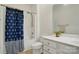 Bathroom with an anchor-themed shower curtain, white vanity with a clear mirror, and neutral colored flooring at 212 Kilborne Rd, Mooresville, NC 28117