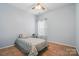 Cozy bedroom featuring neutral walls, carpet, ceiling fan and a single bed by a window, offering a serene retreat at 212 Kilborne Rd, Mooresville, NC 28117