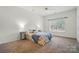 Comfortable bedroom featuring a ceiling fan, soft carpet, and a bright window at 212 Kilborne Rd, Mooresville, NC 28117