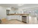 Open kitchen with stainless steel dishwasher, granite countertops, and wood flooring at 212 Kilborne Rd, Mooresville, NC 28117