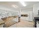 Bright and modern kitchen with granite countertops, white cabinetry, and stainless steel appliances at 212 Kilborne Rd, Mooresville, NC 28117