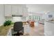 Office space with a built-in desk area leading to open plan dining and living areas at 212 Kilborne Rd, Mooresville, NC 28117