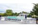 Community pool area featuring lounge chairs, tables with umbrellas, and a covered seating area at 212 Kilborne Rd, Mooresville, NC 28117