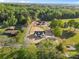 Expansive aerial view of a home site showcasing the neighborhood and verdant tree coverage at 215 Scout Rd, Locust, NC 28097