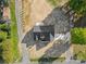 An aerial view of a home showcasing its fresh driveway and professional landscaping at 215 Scout Rd, Locust, NC 28097