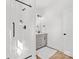 Modern bathroom with a glass shower and a gray vanity with quartz countertop at 215 Scout Rd, Locust, NC 28097
