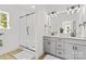 This primary bathroom features a glass enclosed shower, double sink vanity, and modern fixtures at 215 Scout Rd, Locust, NC 28097