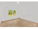 Bright bedroom with luxury vinyl plank flooring and a large window at 215 Scout Rd, Locust, NC 28097