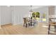 Bright dining area features a modern chandelier, stylish table with bench, white wainscoting, and natural light at 215 Scout Rd, Locust, NC 28097