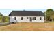 Exterior view of the rear of the property with white siding and a dark roof at 215 Scout Rd, Locust, NC 28097