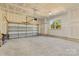 Spacious two car garage with an automatic door and natural light from window at 215 Scout Rd, Locust, NC 28097
