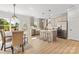 Open-concept kitchen and dining area with stainless steel appliances and center island at 215 Scout Rd, Locust, NC 28097