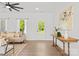 Bright open-concept living room featuring hardwood floors, neutral decor, and ample natural light at 215 Scout Rd, Locust, NC 28097
